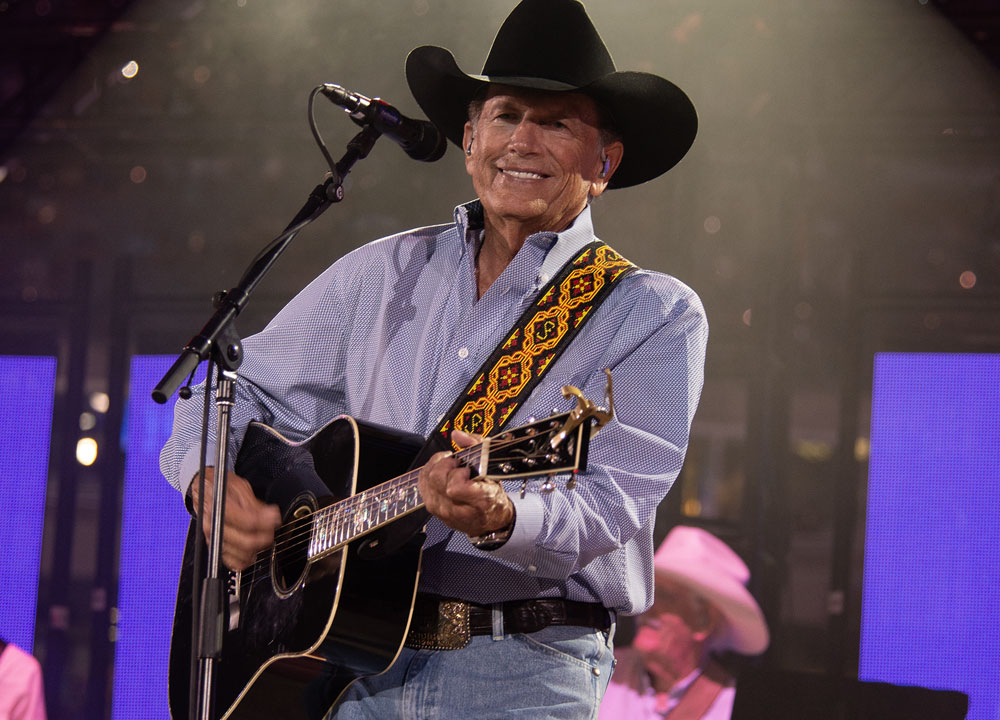 George Strait performing on a stage.